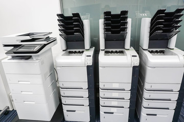 four printer machines in office ready for business documents