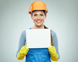 Happy smiling woman builder holding white banner.