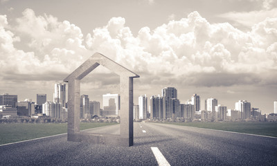 Conceptual background image of concrete home sign on asphalt roa