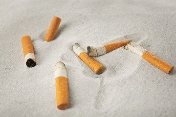 Cigarette butts on sand