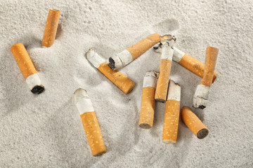 Cigarette butts on sand