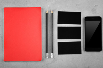 Stationery with business cards and smart-phone on light background