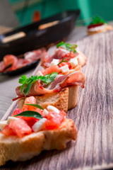 Set of bruschetta on wooden background. Crostini.