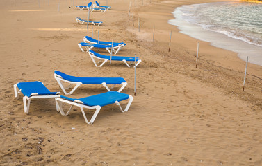 Sunbeds on the sea beach, top view