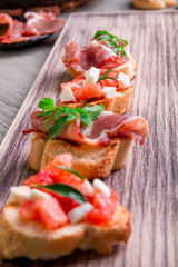 Set of bruschetta on wooden background. Crostini.