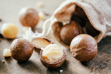 Macadamia nuts on wooden board. Healthy food