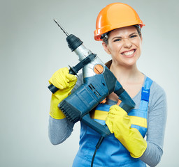 Hard work of woman builder with drill tool.