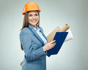 Smiling woman architect holding paper plans  and clipboard.