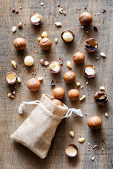 Shelled and unshelled Macadamia nuts on wooden board