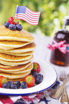 Stack of pancakes with fresh fruit