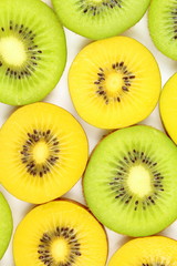 slices of fresh green and yellow kiwi fruits food background texture