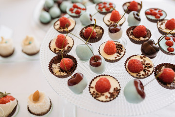 Candy Bar. Delicious sweet buffet with cupcakes. Sweet holiday buffet with cupcakes and other desserts. Table with sweets, candies, dessert