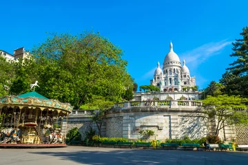 Fotobehang Sacre Coeur Basilica in Paris at day with blue bright sky and green grass and blooming trees. © HappyRichStudio
