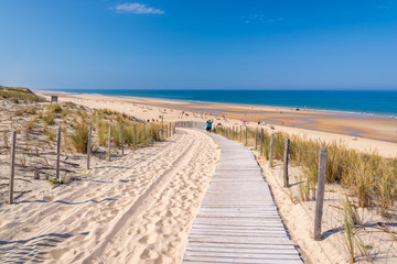 Fototapeta na wymiar Wooden path in the sand dune and the beach of Lacanau, atlantic ocean, France