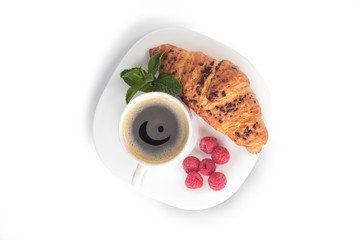 a cup of coffee and croissant isolated on white