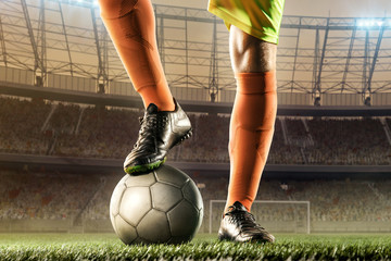 feet of soccer player on soccer ball for kick-off