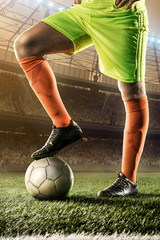 Fototapeta na wymiar feet of soccer player on soccer ball for kick-off