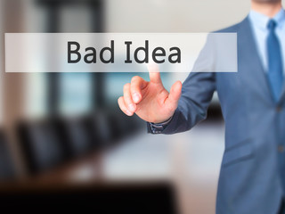 Bad Idea - Businessman hand pressing button on touch screen interface.