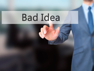 Bad Idea - Businessman hand pressing button on touch screen interface.