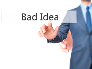 Bad Idea - Businessman hand pressing button on touch screen interface.