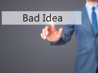 Bad Idea - Businessman hand pressing button on touch screen interface.