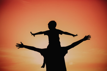 father and son having fun at sunset