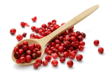Red peppercorns in a wooden spoon