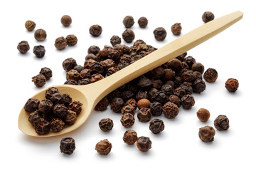Black peppercorns in a wooden spoon
