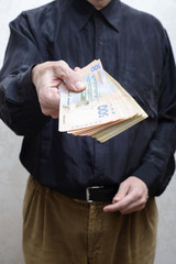 Businessman, or politician, offering a Hryvnia banknotes bribe for corruption, in Ukraine