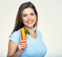 Beautiful smiling  woman holding glass with carrot.