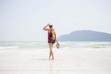Fototapeta na wymiar Young girl in hat on seashore