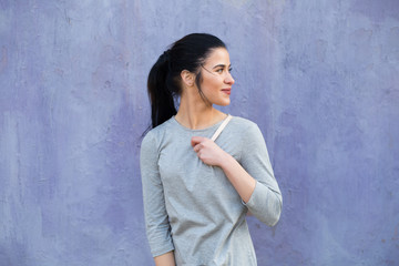 Stylish pretty woman portrait against a violet wall background