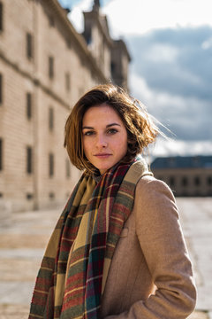 Young woman in coat posing