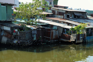 Fototapeta na wymiar Riverside slum, houses near polluted river
