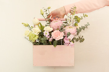 Pink wooden box with flowers roses and carnations