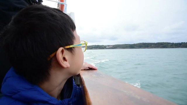 Young happy asian boy on the ship