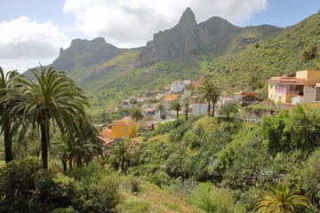 Gordijnen IMADA, LA GOMERA, SPAIN: Mountainous and green landscape with Imada village in the background and cactuses in the foreground © Christophe Cappelli