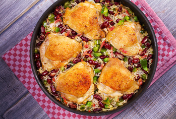 Chicken with Rice, Beans, Bacon and Green Pepper in Pan. View from above, top studio shot