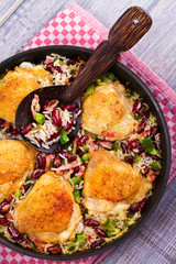 Chicken with Rice, Beans, Bacon and Green Pepper in Pan. View from above, top studio shot