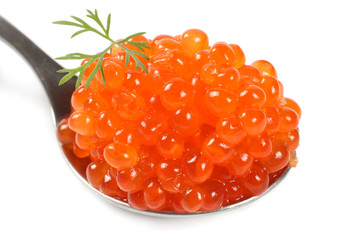 Red caviar in the silver spoon isolated on a white background. Macro.