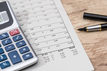 business concept  - financial reports with calculator, pen.