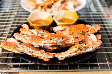 grilled crabs on plate at street market