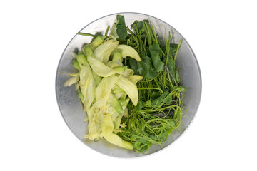 Boiled coccinia grandis and sesbania grandiflora vegetables on stainless steel plate isolated on white