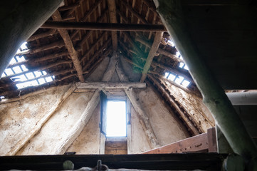 low angle view of a broken roof with holes in it