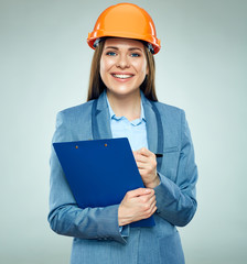 Smiling businesswoman builder holding clipboard with contract