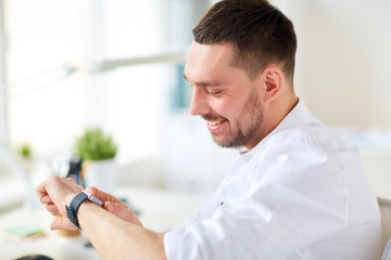 close up of businessman with smartwatch at office