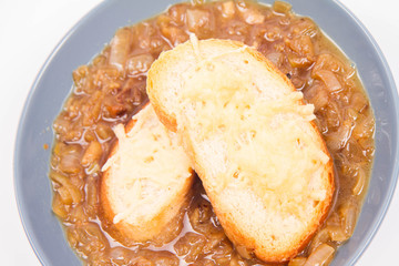 Onion soup with toast on a white background