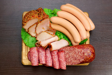 Assorted meat products including ham and sausages.
