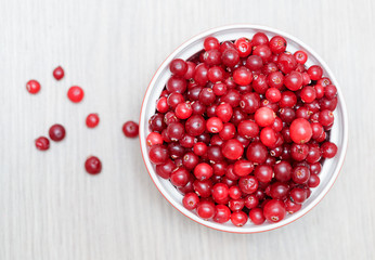 bowl of cowberries on old wooden table