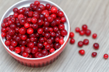 bowl of cowberries on old wooden table